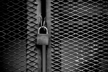 lock at cage metal wire - monochrome background