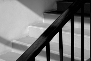 Modern metal railing at staircase with shadow in a modern concrete building