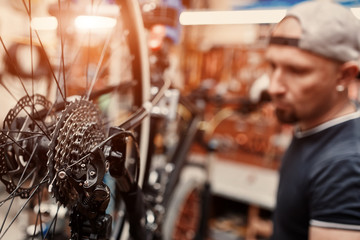 Mechanic repairing bicycle in his workshop