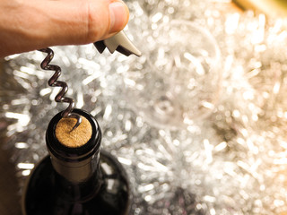 Corkscrew and bottle of red wine. Opening a bottle of wine. Close-up.
