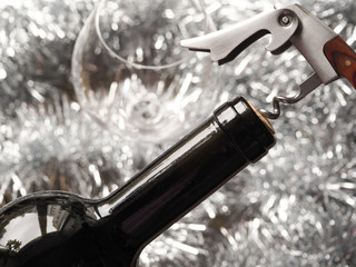 Corkscrew and bottle of red wine. Opening a bottle of wine. Close-up.
