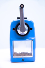 Blue pencil sharpener machine on white background.