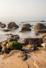 Fototapeta na wymiar Rocks at atlantic seaside in low tide on a fog day