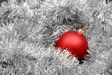 Red christmas ball on silver tinsel