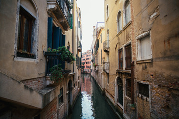 Fototapeta na wymiar Water runs in the canel between houses in Venice