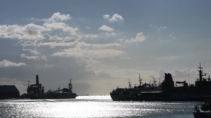 MAURITIUS, MAY 22, 2017. Black silhouettes of cargo ships arriving at Port Louis, in Mauritius on May 22nd 2017. 