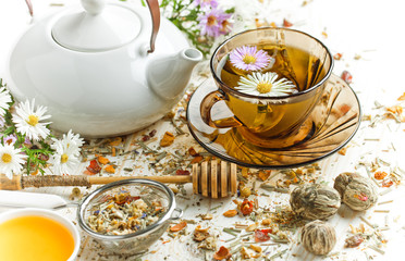 Dry flower tea leaves on a white background in a composition on a table