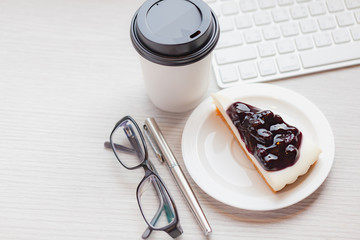 Disposable coffee cup with blueberry chess pie.