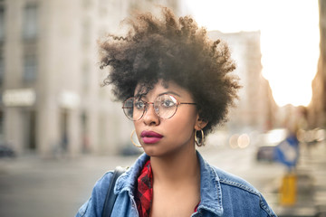 Portrait of a fashionable girl with curly hair