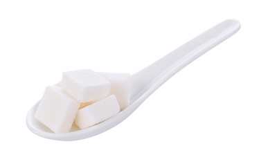 sugar cube in spoon on white background
