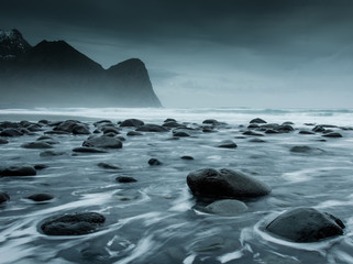 Fototapeta na wymiar Long exposure of the sea on the coast of the Lofoten Islands with round rocks in the foreground 1