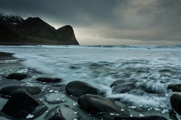 Long exposure of the sea on the coast of the Lofoten Islands with round rocks in the foreground 2