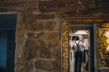 Reflection of smiling wedding couple dancing in the room