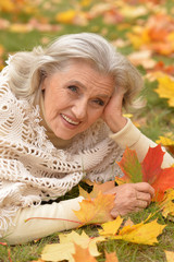 woman holding autumn leaf