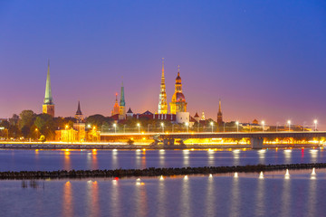 Old Town of Riga and River Daugava at night, Riga Cathedral, Saint Peter church, Cathedral Basilica of Saint James and Riga castle in the background, Latvia
