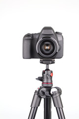 Black DSLR Camera on tripod isolated on white background