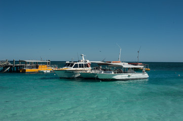 boats on clear ocean 