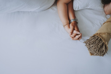 Naklejka premium Hand in hand of young couple in bed