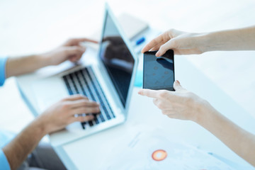 Close up of business people using different gadgets