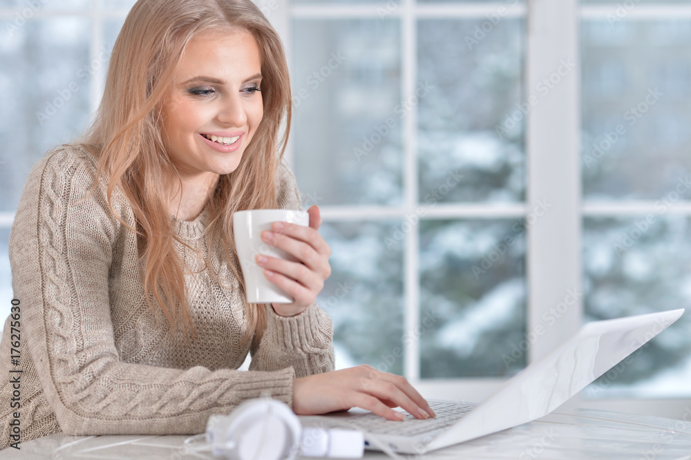 Wall mural woman using at laptop