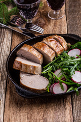 Roast pork fillet with with arugula and radish salad