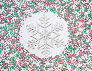 Confetti in christmas decoration color with snowflake on white background.flat lay
