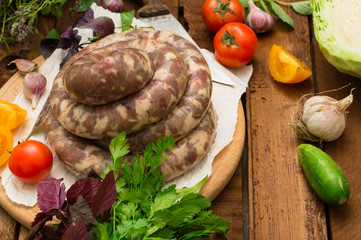 Raw fresh sausages in a white plate on a wooden background. Top view. Close-up