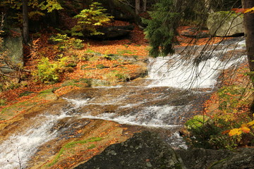Čern&aacute; Desn&aacute;, a watercourse running in the north of the Czech Republic in the Jizera Mountains.Forest waterfall with autumn color change. Beautiful nature
