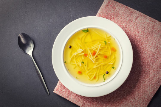 Homemade chicken soup with noodles, top view