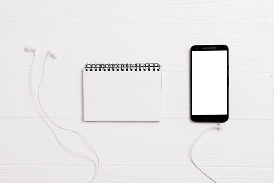 Minimal work space - Creative flat lay photo of workspace desk with sketchbook and mobile phone with white screen on copy space white background. Top view , flat lay photography.