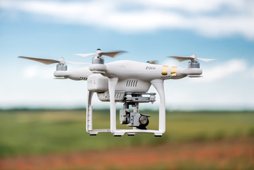 Image of a drone against green meadow