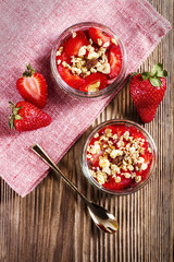 homemade healthy strawberry desserts on a wooden table, view from top