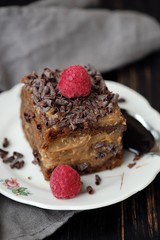 Delicious chocolate cake with raspberries on the table
