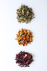 Various kind of leaf tea on a white background, top view