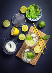 Mojito drinks preparation on a black kitchen table