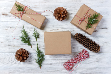 Christmas background with hand crafted gifts, presents on rustic wooden table. Christmas or New year DIY packing. Holiday decor concept. Overhead, flat lay, top view