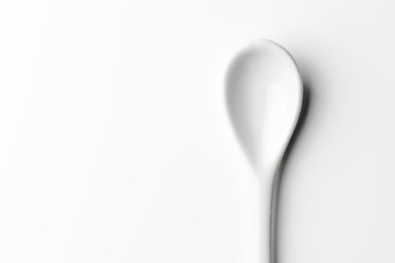 White spoon isolated on a white surface