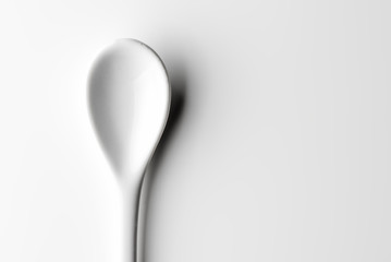 White spoon isolated on a white surface