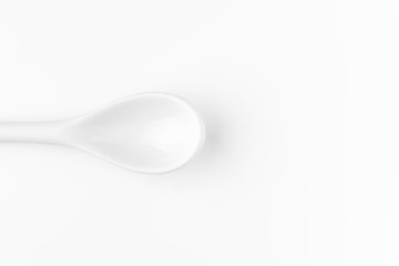 White spoon isolated on a white surface