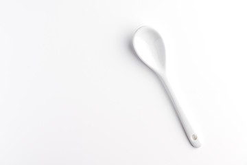 White spoon isolated on a white surface