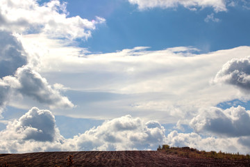 Heavenly landscape. Cloudy blanket over autumn field. 