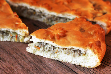 Homemade australian meat pie on the wooden table closeup