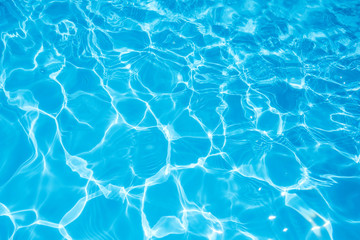 Fototapeta na wymiar Blue and bright water surface and ripple wave with sun reflection in swimming pool
