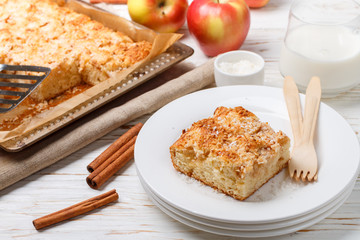 Homemade Apple pie with coconut, cinnamon and powdered sugar. Traditional delicious pastries for tea. Selective focus