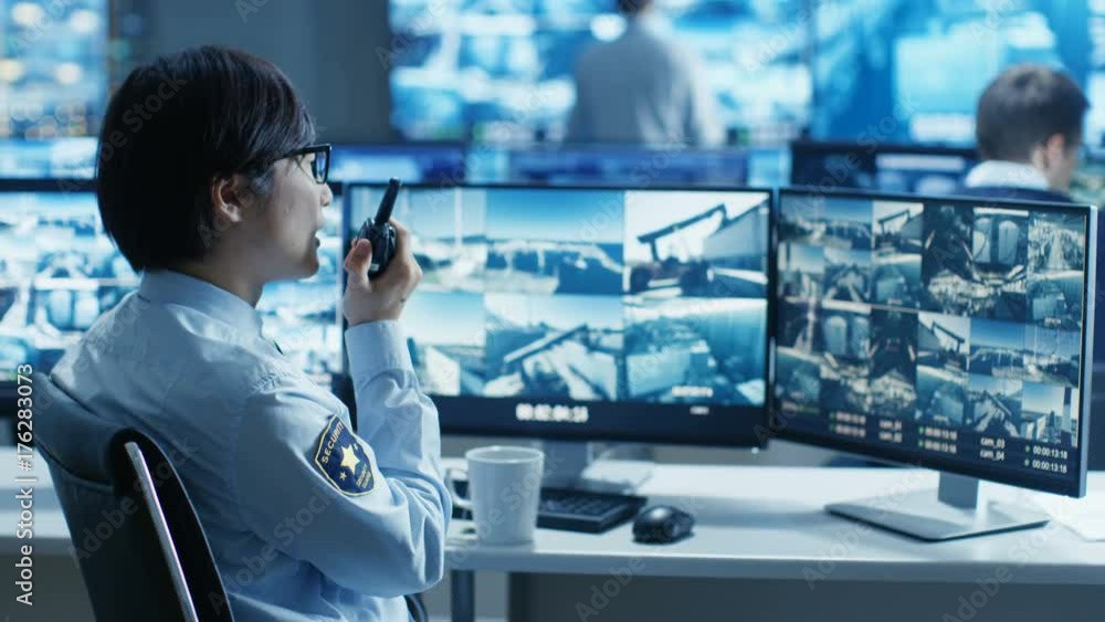 Poster in the security control room officer monitors multiple screens for suspicious activities, he reports