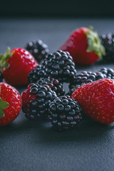 Fresh strawberries and blackberries on a table
