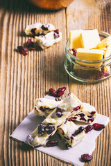 Pieces of white chocolate on a wooden table