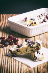 White chocolate with cranberries on a wooden table