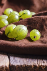 Gooseberries on a brown tablecloth, closeup