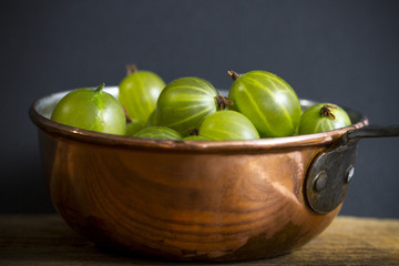 Gooseberries in a copper pot